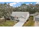 Single-story house with a gray roof, and a spacious yard at 5505 Tangelo St, Leesburg, FL 34748