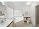 Clean bathroom with corner bathtub, toilet, and vanity at 5505 Tangelo St, Leesburg, FL 34748