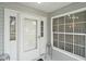 Front entry with white door, sidelights, and window at 5505 Tangelo St, Leesburg, FL 34748