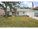 Single story home with gray siding, white door and garage at 5505 Tangelo St, Leesburg, FL 34748