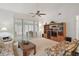 Living Room with wood-toned furniture and access to a screened porch at 5505 Tangelo St, Leesburg, FL 34748