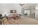Living Room with floral couches and a view into a screened porch at 5505 Tangelo St, Leesburg, FL 34748