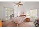 Spacious main bedroom with sliding door to a screened patio at 5505 Tangelo St, Leesburg, FL 34748
