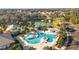 Aerial view of community pool, tennis courts, and clubhouse at 5616 Illumination Ln, Leesburg, FL 34748