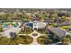 Clubhouse and surrounding landscape with palm trees and paved walkways at 5616 Illumination Ln, Leesburg, FL 34748