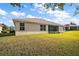 Landscaped backyard with grassy area at 5616 Illumination Ln, Leesburg, FL 34748