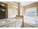 Bathroom with double vanity, bathtub, and separate shower at 5616 Illumination Ln, Leesburg, FL 34748