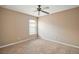 Well-lit bedroom with carpeted floor and ceiling fan at 5616 Illumination Ln, Leesburg, FL 34748