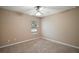 Simple bedroom with carpeted floor and a window at 5616 Illumination Ln, Leesburg, FL 34748