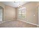 Simple dining area with carpeted floor and large window at 5616 Illumination Ln, Leesburg, FL 34748