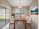 Bright dining room with wood table and access to the outdoors at 5616 Illumination Ln, Leesburg, FL 34748