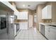 Kitchen with stainless steel appliances and white cabinets at 5616 Illumination Ln, Leesburg, FL 34748