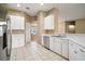 Kitchen with stainless steel appliances and white cabinets at 5616 Illumination Ln, Leesburg, FL 34748