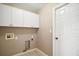 Laundry room with white cabinets and built-in shelving at 5616 Illumination Ln, Leesburg, FL 34748