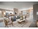 Open living room features stylish furniture and a view into the kitchen at 5616 Illumination Ln, Leesburg, FL 34748