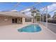 Relaxing kidney-shaped pool with screened enclosure at 571 Smithfield Pl, The Villages, FL 32162