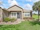 House entrance with black door and stone walkway at 572 Dowling Cir, Lady Lake, FL 32159