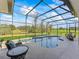 Screened-in pool and patio furniture overlooking the golf course at 572 Dowling Cir, Lady Lake, FL 32159