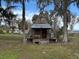 A-frame cabin with metal roof, wooden porch, and surrounding trees at 668 County Road 485, Lake Panasoffkee, FL 33538