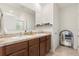 Double vanity bathroom with granite countertop and large mirror at 707 Chinoy Rd, Davenport, FL 33837