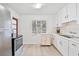 Kitchen with white cabinets and stainless steel appliances at 714 Park Dr, Leesburg, FL 34748