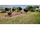 Landscaped backyard with manicured lawn and stone border at 8633 Se 133Rd Ln, Summerfield, FL 34491