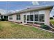 Landscaped backyard with a large sunroom addition at 8633 Se 133Rd Ln, Summerfield, FL 34491