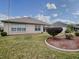 Spacious backyard with grassy lawn and well-manicured landscaping at 8633 Se 133Rd Ln, Summerfield, FL 34491