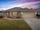 Well-maintained house with a landscaped lawn and a two-car garage at 8633 Se 133Rd Ln, Summerfield, FL 34491