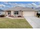 Single-story home with attached garage and nicely landscaped front yard at 8633 Se 133Rd Ln, Summerfield, FL 34491