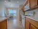 Bright kitchen with wood cabinets, white appliances, and breakfast nook at 8633 Se 133Rd Ln, Summerfield, FL 34491
