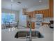 Kitchen featuring wood cabinets, white appliances, and a breakfast nook at 8633 Se 133Rd Ln, Summerfield, FL 34491