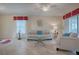Living room featuring light leather sofas and a glass coffee table at 8633 Se 133Rd Ln, Summerfield, FL 34491