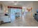 Spacious living room with light tile floors and access to a lanai at 8633 Se 133Rd Ln, Summerfield, FL 34491