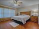 Spacious main bedroom with wood flooring and ceiling fan at 8633 Se 133Rd Ln, Summerfield, FL 34491