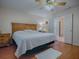Main bedroom with king bed, wood furniture, and ensuite bath at 8633 Se 133Rd Ln, Summerfield, FL 34491