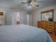 Main bedroom with king bed, dresser, and ensuite bath at 8633 Se 133Rd Ln, Summerfield, FL 34491