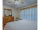 Main bedroom with king bed, dresser and large window at 8633 Se 133Rd Ln, Summerfield, FL 34491