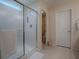 Walk-in shower with glass enclosure and tiled walls at 8633 Se 133Rd Ln, Summerfield, FL 34491