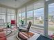 Relaxing sunroom with ample natural light and comfy seating at 8633 Se 133Rd Ln, Summerfield, FL 34491