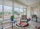 Sunroom with multiple windows, comfortable seating and backyard view at 8633 Se 133Rd Ln, Summerfield, FL 34491