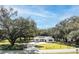 Aerial view of a white house on a tree-lined property at 871 Cr 548, Bushnell, FL 33513