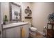 Stylish powder room with a single vanity, toilet, and decorative wall art at 871 Cr 548, Bushnell, FL 33513