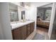 Elegant bathroom with dual sinks, a large mirror, and a walk-in shower at 871 Cr 548, Bushnell, FL 33513