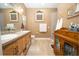 Double vanity bathroom with light wood cabinets and walk-in shower at 871 Cr 548, Bushnell, FL 33513