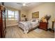 Serene bedroom with a double bed, window, and wood furnishings at 871 Cr 548, Bushnell, FL 33513