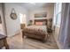 Bright bedroom with wood-framed bed, coastal decor, and a view at 871 Cr 548, Bushnell, FL 33513