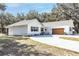 White farmhouse with a charming front porch and landscaping at 871 Cr 548, Bushnell, FL 33513