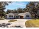 Farmhouse exterior with attached garage and circular driveway at 871 Cr 548, Bushnell, FL 33513