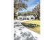 Farmhouse style home with a circular driveway and landscaping at 871 Cr 548, Bushnell, FL 33513